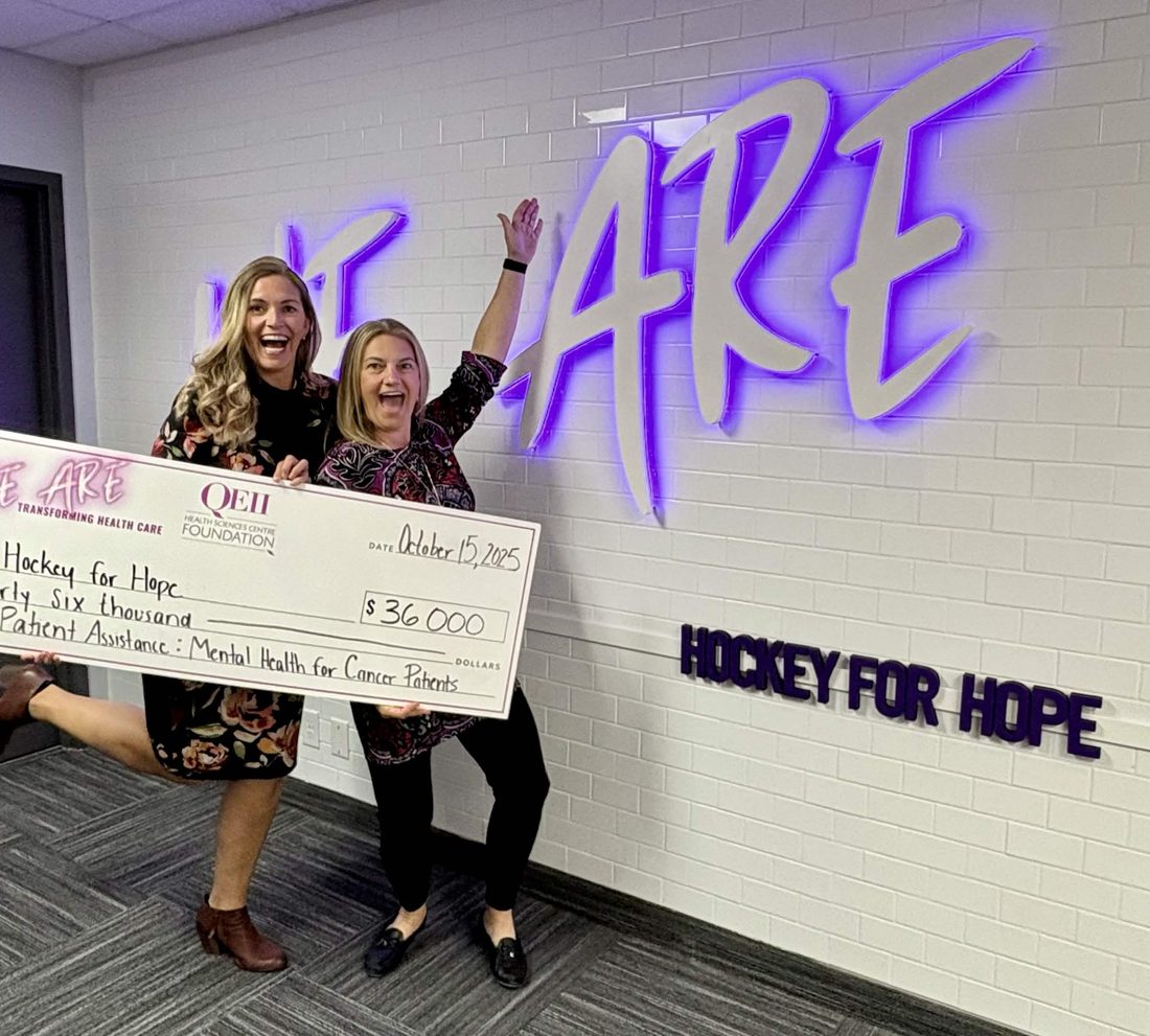 Two organizers celebrating with an oversized cheque for thirty-six thousand dollars made out to Hockey for Hope for mental health support for cancer patients