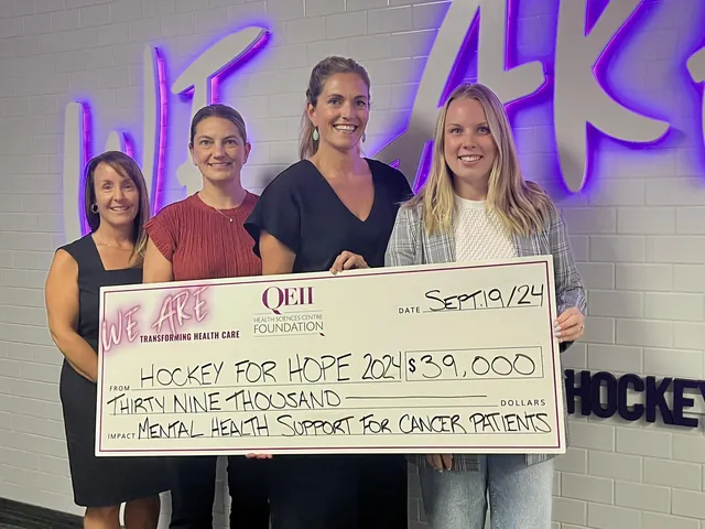 Four organizers holding an oversized cheque for thirty-nine thousand dollars